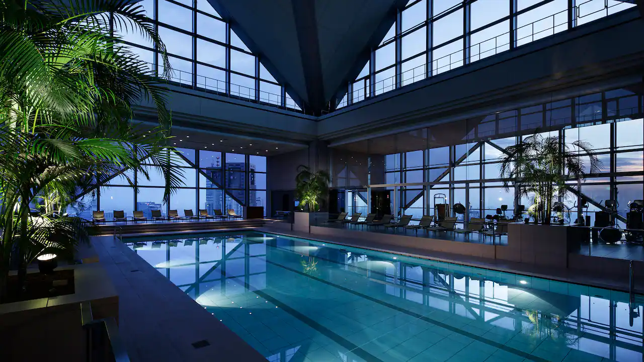 Indoor swimming pool with large glass windows looking over Tokyo from the Park Hyatt Hotel in Shinjuku