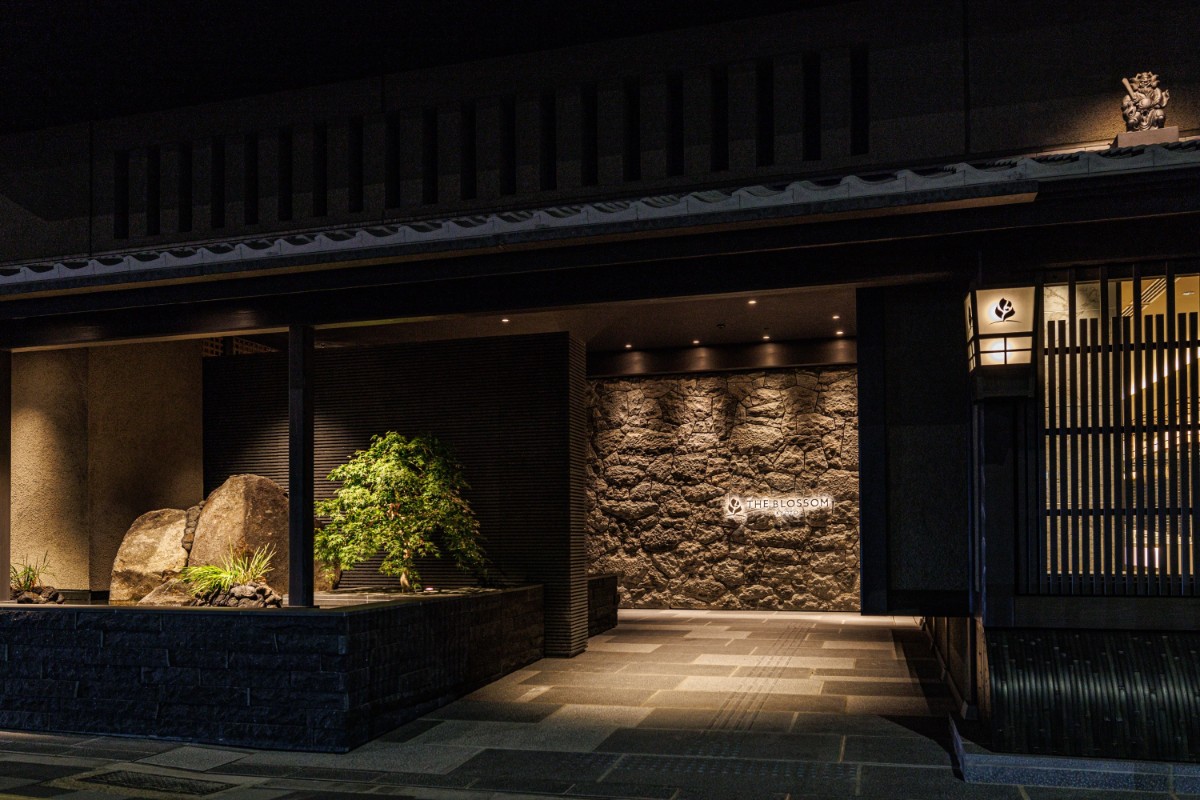 Entrance to a hotel in Kyoto at night with dim lights outside
