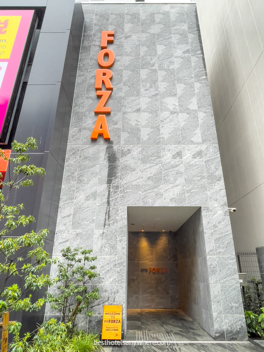 Entrance to Hotel Forza in Dotonbori Namba Osaka narrow grey building with orange letters
