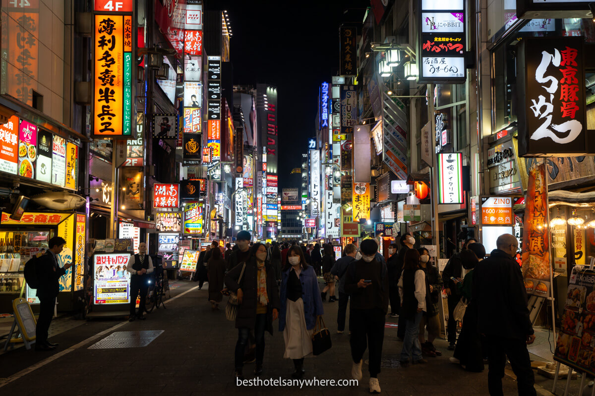Crowded streets with neon lights in Shinjuku Tokyo at night