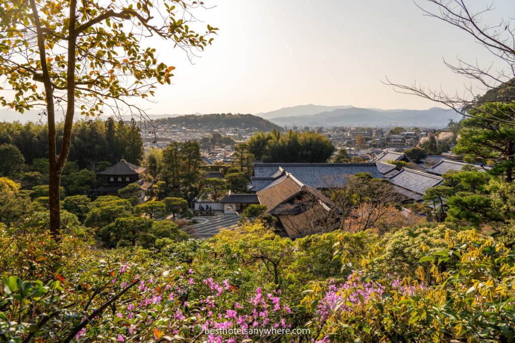View over vegetation, trees and traditional Japanese style buildings in Kyoto at dusk