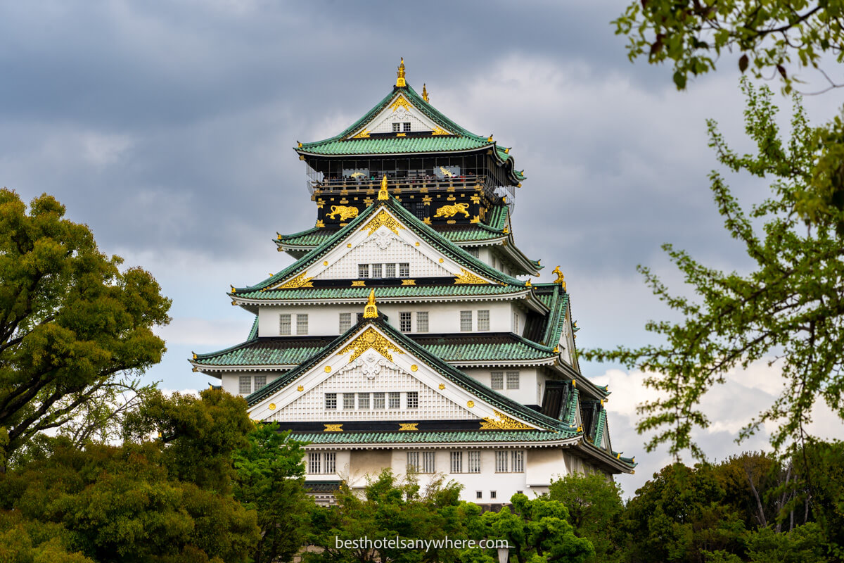 Osaka Castle framed with trees and vegetation on a cloudy day in Japan