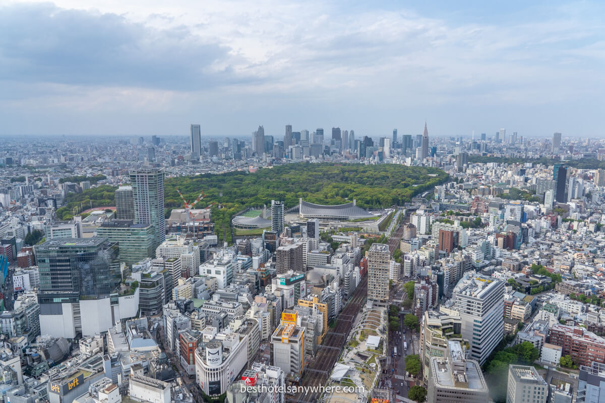 View over Shibuya and Shinjuku from an elevated observation deck in Tokyo on a cloudy day
