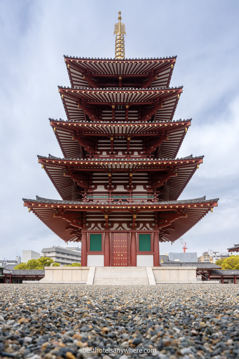 Tall and narrow 5 tiered pagoda Shittenoji Temple in Osaka on a cloudy day