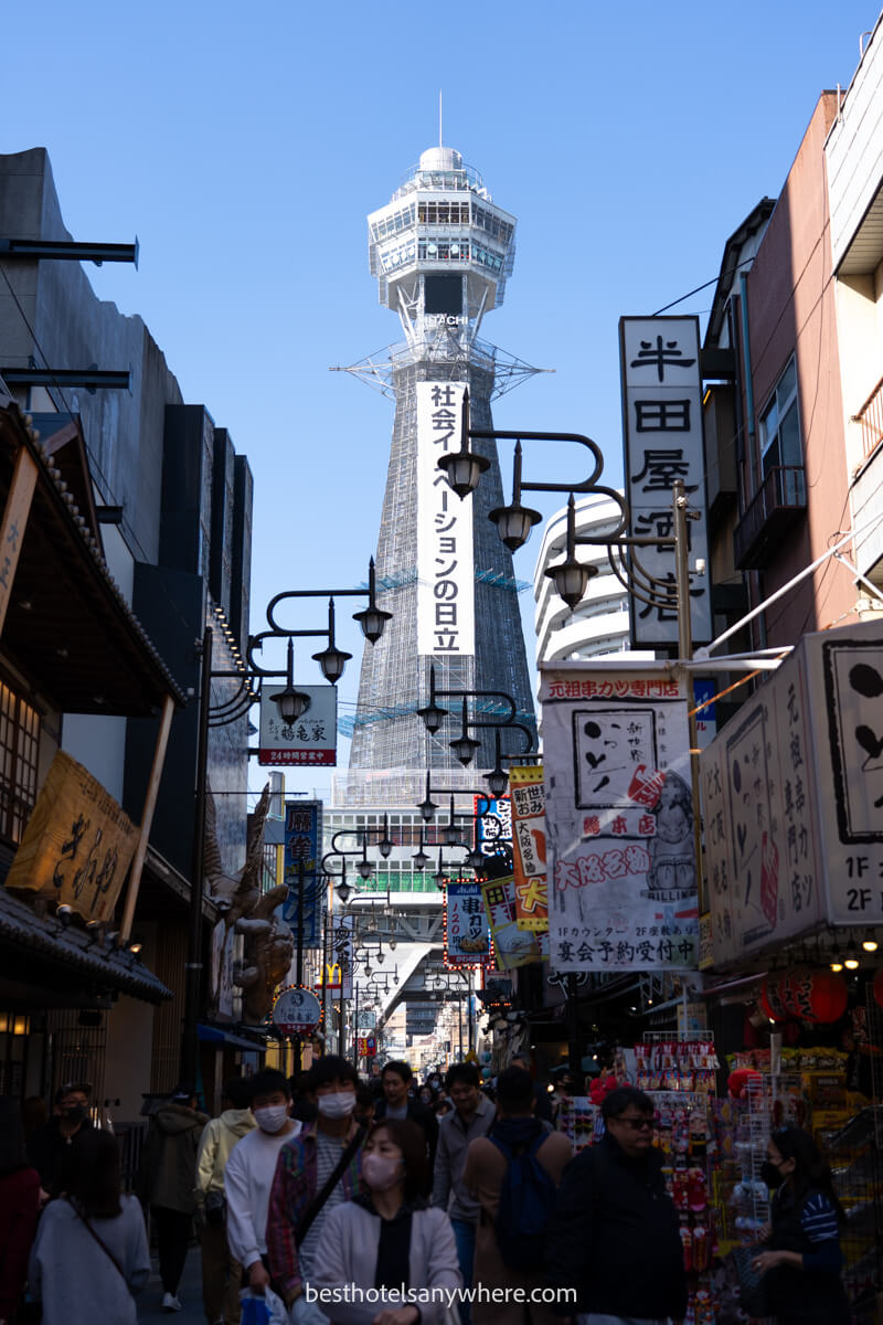 Tsutenkaku Tower in Osaka with crowds of shoppers lining the streets below