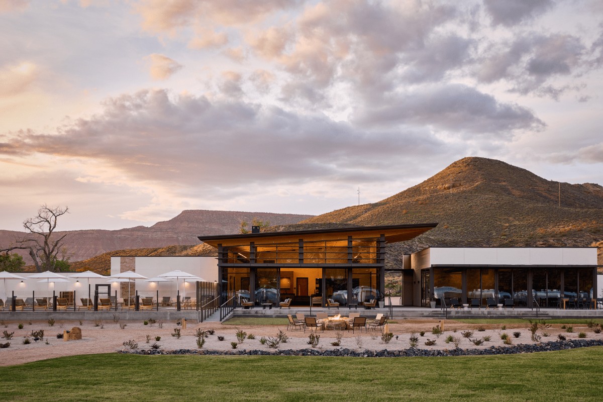 Photo of a luxury glamping style hotel in Virgin Utah at sunset with red rock cliffs behind