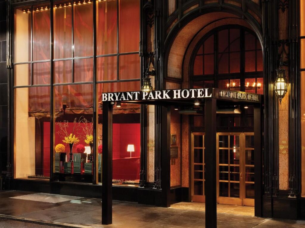 Exterior photo of the entrance to Bryant Park Hotel at night