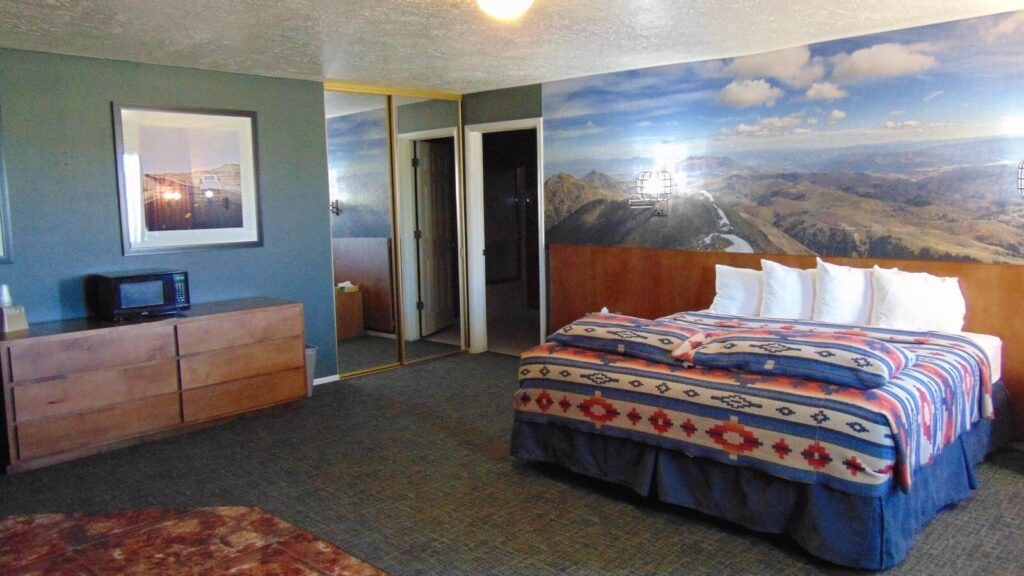 Guest bedroom at a resort motel with bed and desk