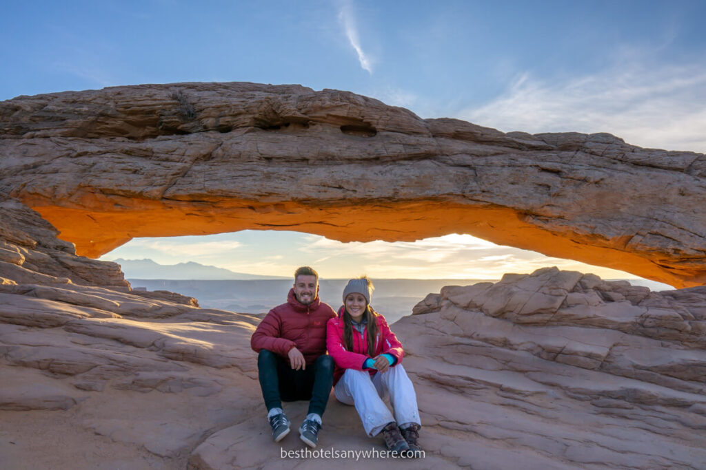 Mark and Kristen from Best Hotels Anywhere at Mesa Arch in Canyonlands national park at sunrise on a cold morning near Moab UT