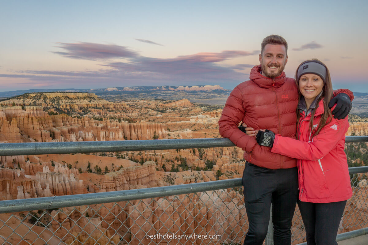 Couple standing at Bryce Canyon amphitheater moments after sunset