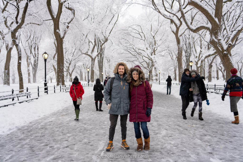 Photo of a couple together in winter coats on The Mall in New York City with snow completely covering the area