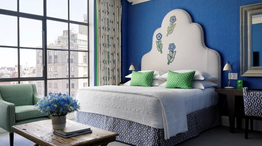 Ultra luxurious guest bedroom with fine furnishings and huge windows at Crosby Street Hotel in NYC