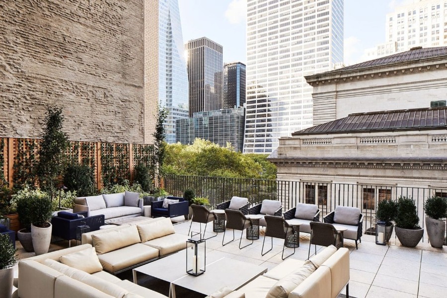 Luxury terrace area with tables and chairs overlooking New York public library on fifth avenue
