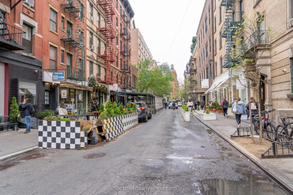 Street in New York City with dining tables spilling out onto the road