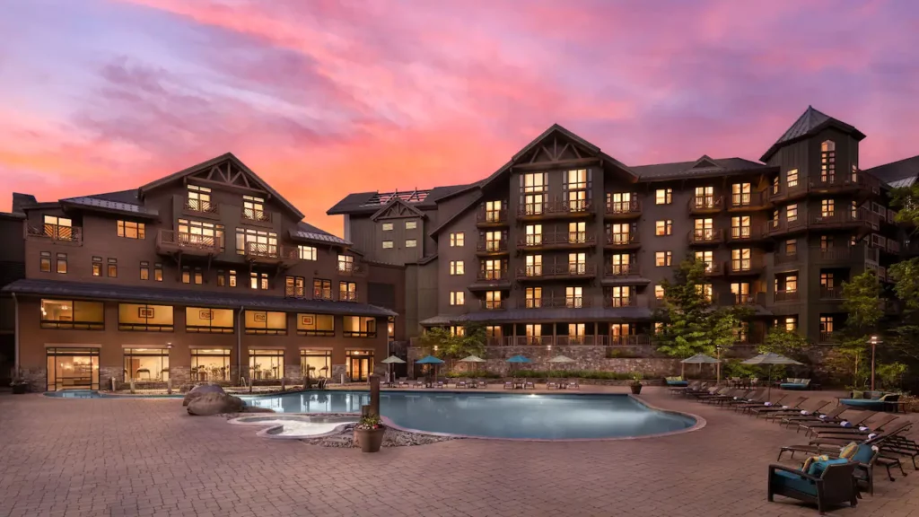 Luxury hotel in Stowe VT with outdoor swimming pool and sunset colors in the sky